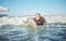 Ocean waves, senior man surfing on beach and healthy fitness lifestyle in Australia summer holiday. Elderly surfer