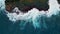 Ocean waves splashing rocky coast top view. Amazing foaming surf crashing beach