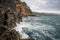 Ocean waves and steep rocks of Madeira island.