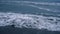 Ocean waves storming beach in dark blue background. Dangerous nature concept.