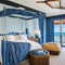Oceanfront Escape: A coastal-inspired master bedroom overlooking the ocean, with a canopy bed, nautical accents, and a balcony t