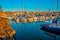 Oceanside Harbor is filled with boats and a lighthouse stands on guard in the background