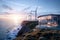 Oceanside Home & Wind Turbines: Sunset Glow on Hillside, generative ai
