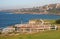 Oceanside town on hill, and picturesque and amazing landscape with grass and white wood fences on cliff by sea in Sydney Australia