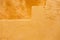 Ocher yellow wall texture grunge background, close up