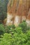 Ochre cliffs and lush foliage below the town of Roussillon, Roussillon, Vaucluse, Provence-Alpes-CÃ´te d`Azur