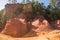 Ochre Trail in Roussillon, Sentier des Ocres, hiking path in a natural colorful area of red and yellow cliffs surrounded by green