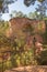 Ochre Trail in Roussillon, Sentier des Ocres, hiking path in a natural colorful area of red and yellow cliffs surrounded by green