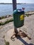 OCHTEN, THE NETHERLANDS - APRIL 21, 2019: Full waste bin on a public place near a river