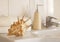 Ð¡ockleshell and Bath white cotton towels, ceramic bottle on Blurred bathroom interior background with sink and faucet