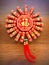 An octagonal firecracker decoration with Good Luck written on it on a brown wooden background.