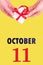 October 11th. Festive Vertical Calendar With Hands Holding White Gift Box With Red Ribbon And Calendar Date