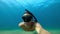 October 15, 2020. Cyprus, Paphos. Selfie of freediver man glides with mask and fins underwater in tropical sea.