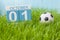 October 1st. Day 1 of month, color calendar on green grass background with a ball. Autumn time. Football and soccer play