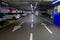 October 2020 Parma, Italy: Underground parking full of cars and marking and road. Back and forth arrows on road