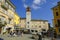 October 2021 Langhirano, Italy: Piazza, square Garibaldi, ctower clock, old town, market with people on a sunny day