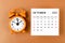 The October 2023 Monthly calendar for the organizer to plan 2023 year with alarm clock on yellow background