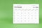 October 2024 desk calendar isolated in green background