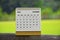 October 2024 white calendar with green blurred background.