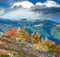 October Carpathian mountain Borghava plateau with first winter snow and autumn colorful bilberry bushes