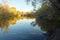 October forest reflected in the calm waters of a lake makes a mirror effect