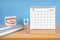 The October monthly desk calendar for 2023 year and model dentures on the table. Dental health concepts