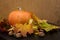 October nature concept with pumpkins, walnuts and autumn leaves