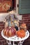 October seasonal harvest display on a wrought iron table near a storefront