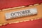 October text on grunge wooden block