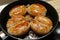 Octoberfet browned sausages frying on the pan