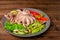 Octopus served with sliced avocado, lettuce, red pepper, lime, c