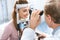 oculist examining patient vision with slit lamp