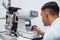 Oculist tests vision of patient by using special modern machine