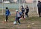 ODESSA, UKRAINE - 03.27.21: Children play football. Little ones go in sports, learn to play football and play in school stadium.