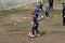 ODESSA, UKRAINE - 03.27.21: Children play football. Little ones go in sports, learn to play football and play in school stadium.