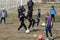 ODESSA, UKRAINE - 03.27.21: Children play football. Little ones go in sports, learn to play football and play in school stadium.