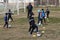 ODESSA, UKRAINE - 03.27.21: Children play football. Little ones go in sports, learn to play football and play in school stadium.