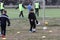 ODESSA, UKRAINE - 03.27.21: Children play football. Little ones go in sports, learn to play football and play in school stadium.