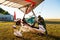 Odessa, Ukraine - July 14, 2016: Pilot preparing young woman for the flight at motor hang glider at small aerodrome.