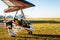 Odessa, Ukraine - July 14, 2016: Young girl with pilot preparing to start the flight at motor hang glider.