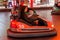 Odessa, Ukraine - June 13, 2016: A group of happy parents, boys and girls having fun and joy ride in bumper car on fairground