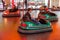 Odessa, Ukraine - June 13, 2016: A group of happy parents, boys and girls having fun and joy ride in bumper car on fairground