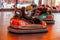 Odessa, Ukraine - June 13, 2016: A group of happy parents, boys and girls having fun and joy ride in bumper car on fairground