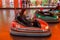 Odessa, Ukraine - June 13, 2016: A group of happy parents, boys and girls having fun and joy ride in bumper car on fairground