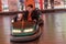 Odessa, Ukraine - June 13, 2016: A group of happy parents, boys and girls having fun and joy ride in bumper car on fairground