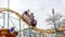 ODESSA, UKRAINE - MAY 6, 2019: Visitors ride road slides in an amusement park. Young friends on an exciting rollercoaster. Young