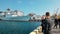 Odessa, Ukraine - September 2019: Civilians on the pier view and photograph the NATO fleet. Several warships moored in