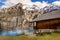 Oeschinnensee, wooden chalet and Swiss Alps, Switzerland.