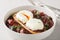 Oeufs en meurette is a classic French dish of poached eggs covered in a rich red wine sauce filled with lardons, mushrooms and