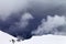 Off-piste slope and storm gray clouds